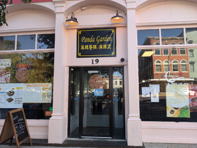 Light pink exterior of Panda Garden restaurant with black and yellow writing.