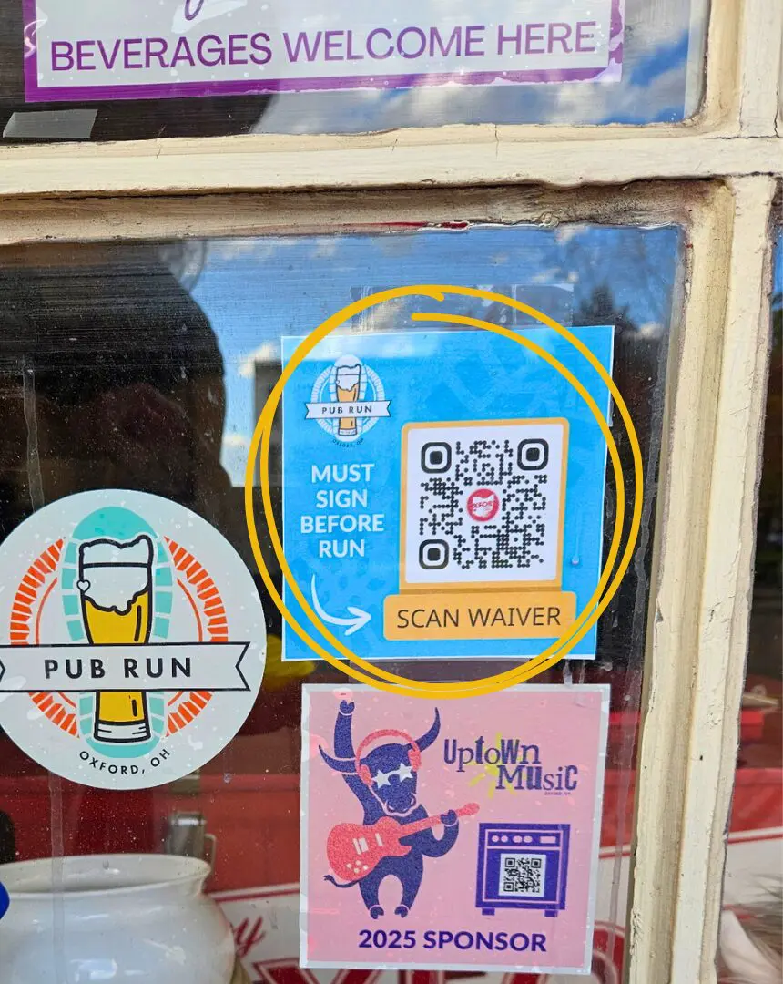 photo of the blue square inside a window of meeting spot with a yellow box QR code for Pub Run waiver.