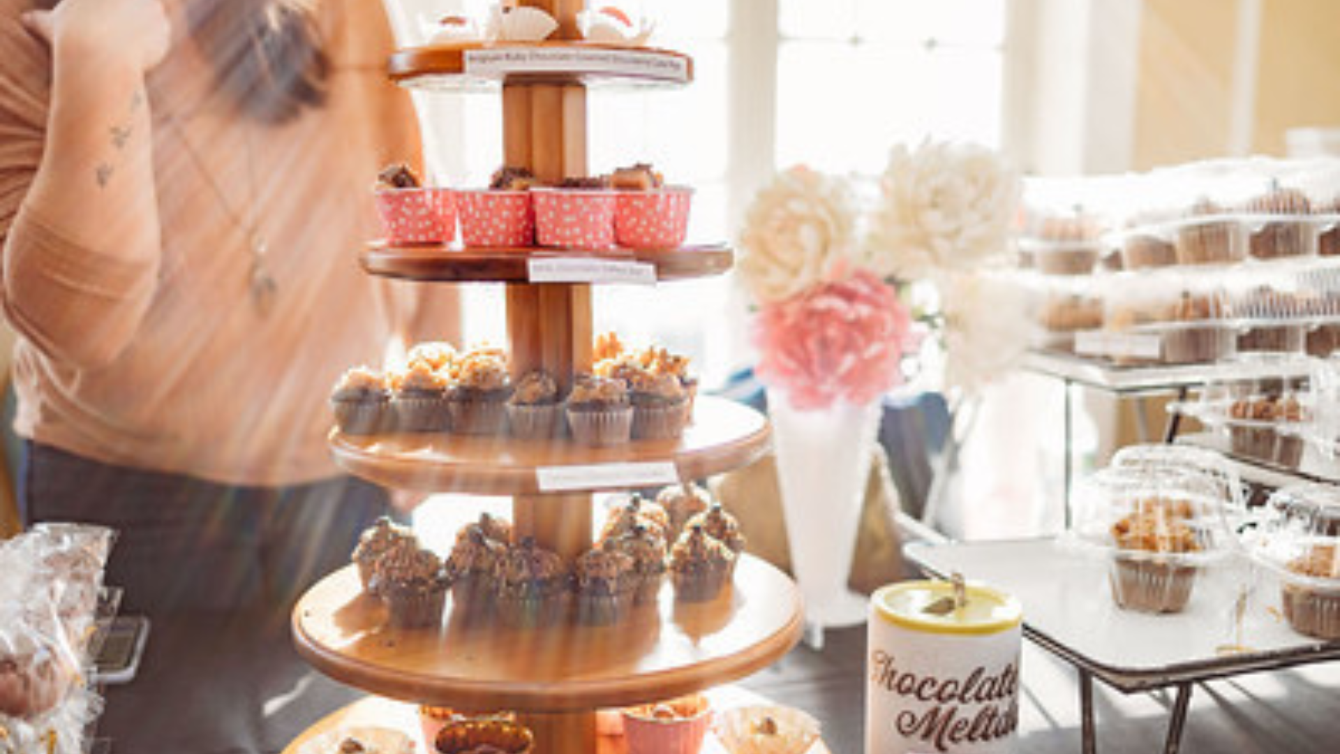 Three-tiered stand of delicious cupcakes.