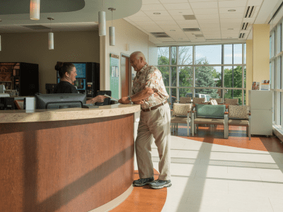 A person standing at a a check-in desk