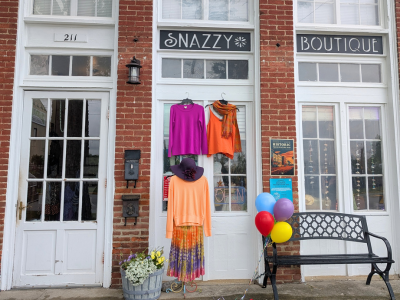 Exterior of Snazzy Threads Boutique and Gifts with white doors and window panels.