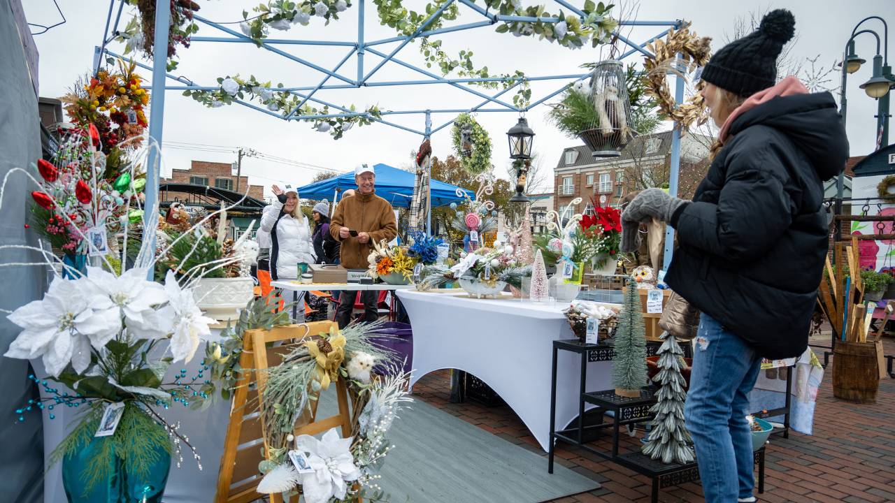 Patrons looking through an artisan vendor tent at Oxford Farm & Flea