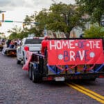 Parade truck with sign that says "Home of the Brave"