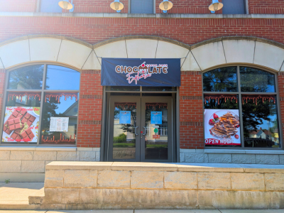 Exterior of Chocolate Euphoria, red brick building with arch windows