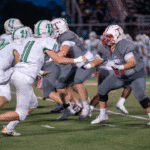 Football players at the line of scrimmage during the Talawanda Varsity football homecoming game.