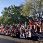 A group of football players rides on a trailer in the Talawanda HS Homecoming parade.