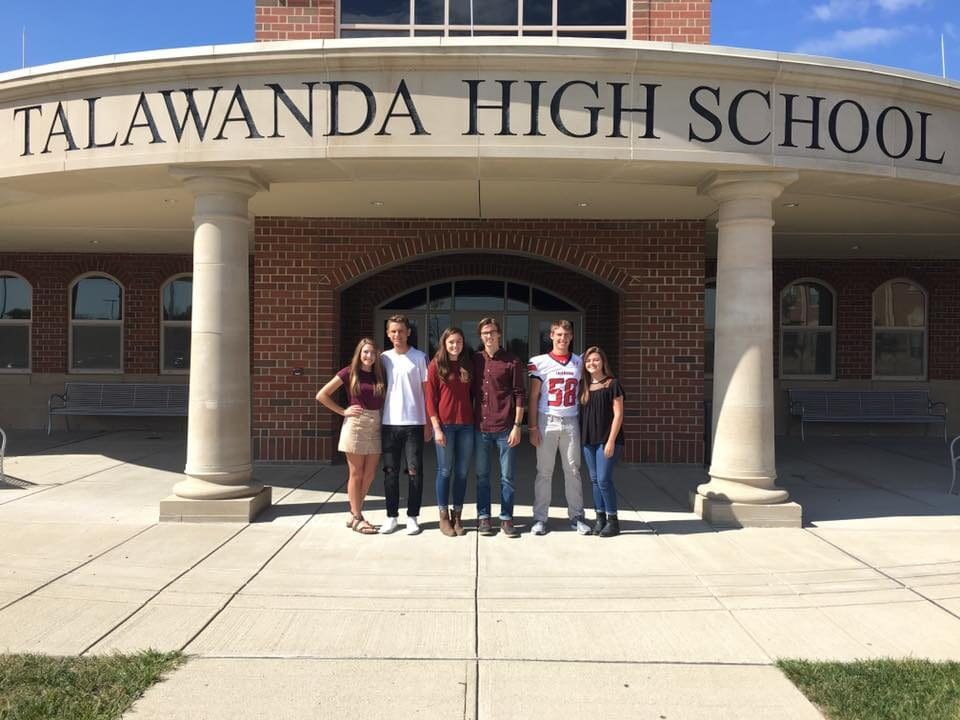 A group of students stands at the entrance of Talawanda High School