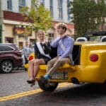 Two members of the Talawanda HS Homecoming Court ride on the back of a car in the parade.