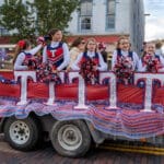 A group of cheerleaders stands on a trailer during the Talawanda HS Homecoming parade.