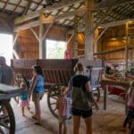 A family explores the Pioneer Barn.