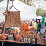 A vendor's table filled with fall decorations