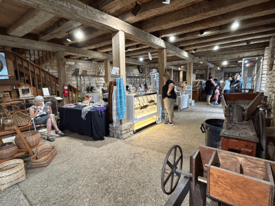Hueston Woods Arts & Crafts Fair vendors inside the barn