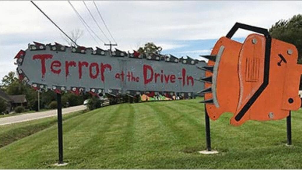 a giant chainsaw with the words Terror at the Drive-in written in fake blood font