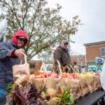 Bags of fresh apples line a local vendor's table.