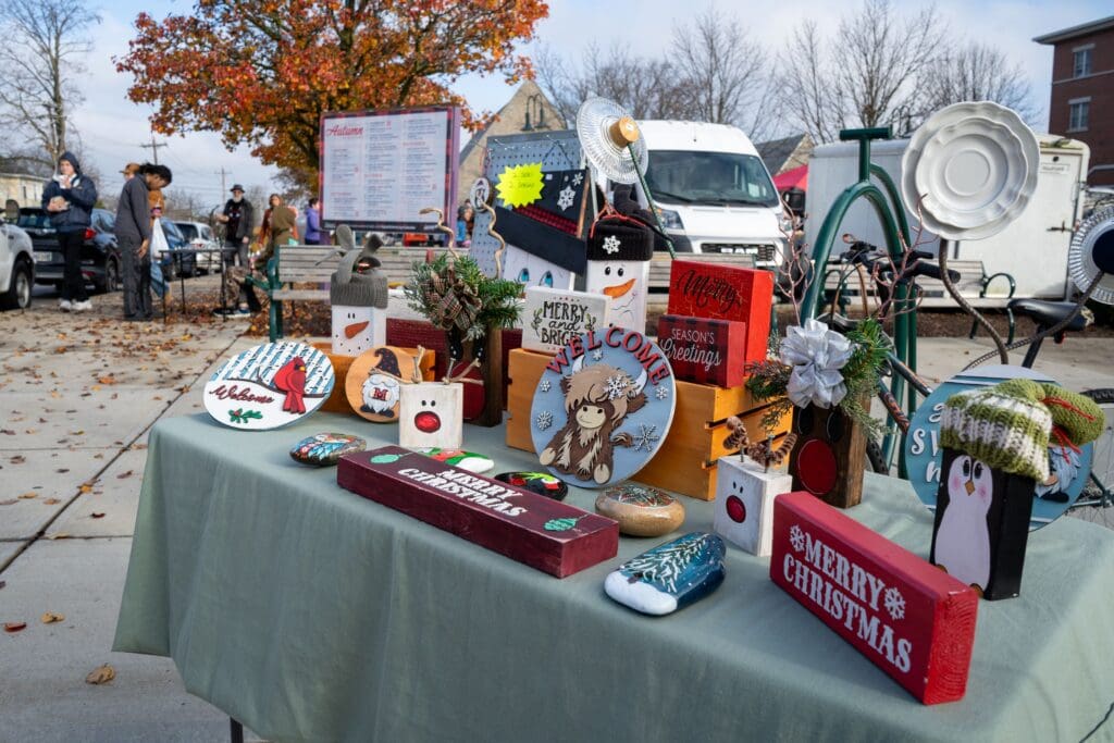 A table filled with holiday decor sits on the sidewalk in Uptown Oxford.