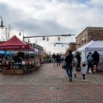 Event attendees explore the various booths lining the streets of Uptown Oxford.