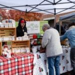 A woman purchases items from a local vendor.