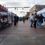 People explore the various vendor booths lining the streets of Uptown Oxford.