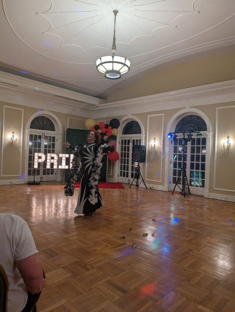 Person performing in elegant ballroom setting.