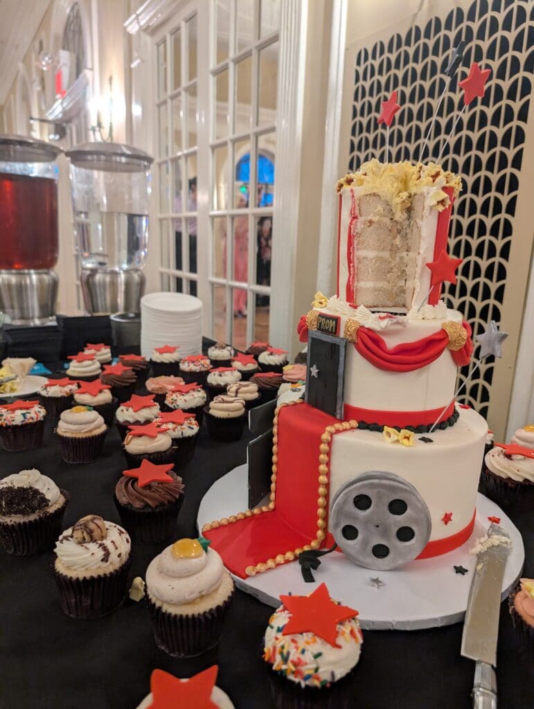 Luke's Custom Cakes three-tiered cake with cupcakes.