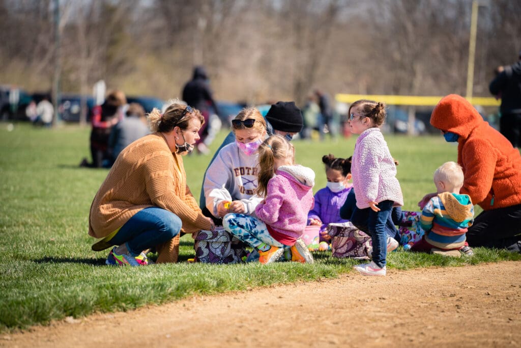 a group of kids and adults counting their collected eggs