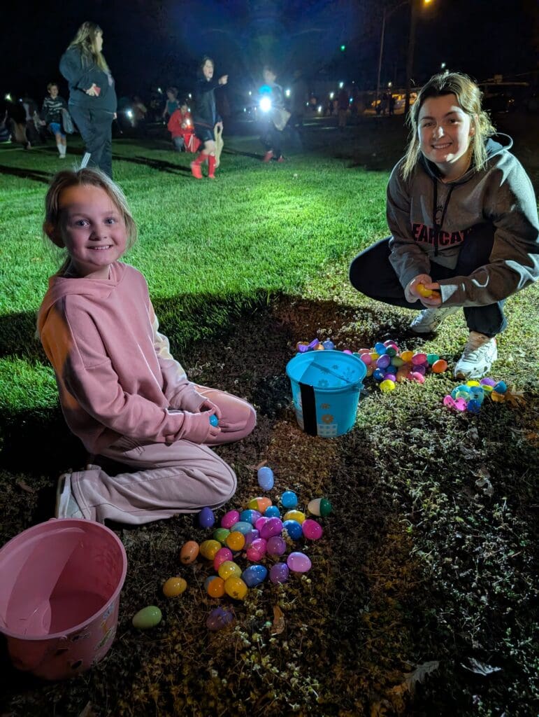 a kid opening their eggs to find a prize ticket