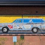 "Changemakers of Oxford" mural shows a photo of the car with names of local Civil Rights activists and events.