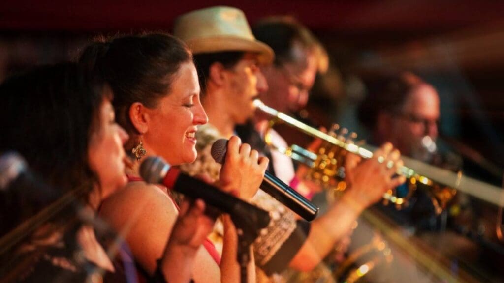 Members of The Wild Honeybees holding and array of musical instruments.