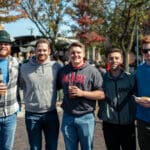 Five guys pose for the camera in the middle of Uptown