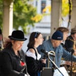 A group of musicians plays their instruments on the main stage.