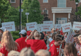 Miami University alumni gathered with class signs