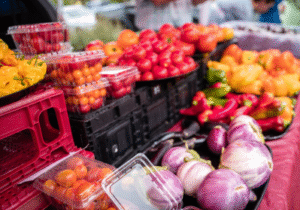 A table full of fresh produce at an outdoor market.