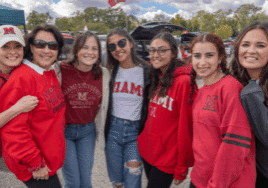 photo of seven women posing for Family Weekend Tailgate party