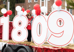 Homecoming parade with large cut out numbers reading "1809" in white with red outline
