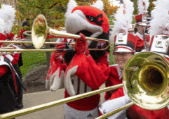Marching band with mascot playing trombone.